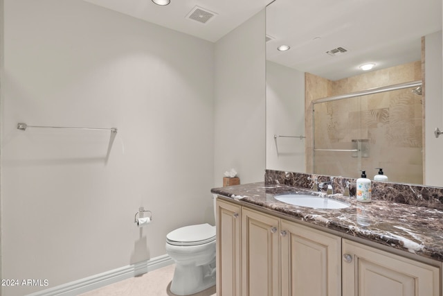 bathroom with tile floors, vanity, and toilet