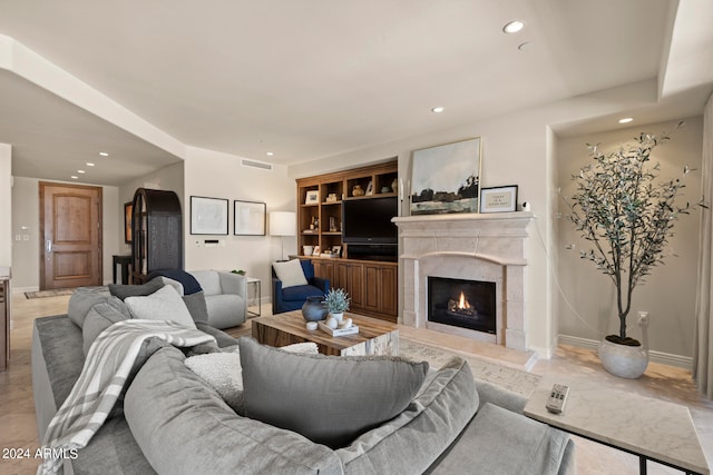 living room featuring a tile fireplace