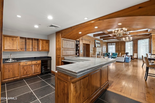 kitchen with wine cooler, dark hardwood / wood-style flooring, beam ceiling, a notable chandelier, and sink