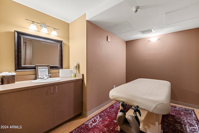 bathroom featuring wood-type flooring and oversized vanity