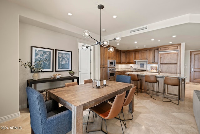 tiled dining area with a notable chandelier