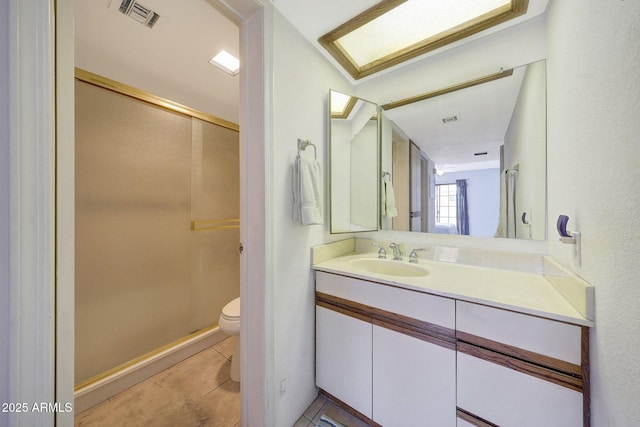 bathroom with tile patterned floors, visible vents, toilet, and vanity