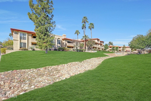 view of property's community with a lawn