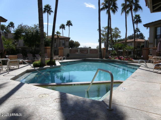 pool featuring fence and a patio area