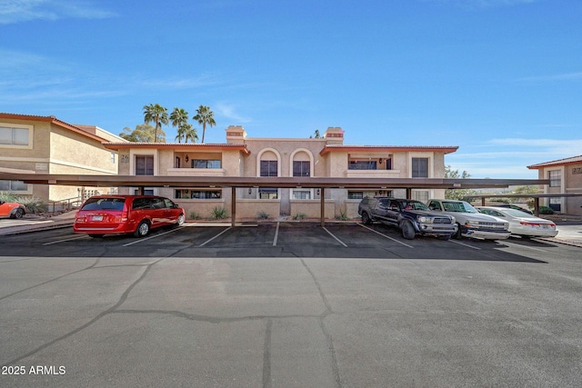 view of property featuring covered parking