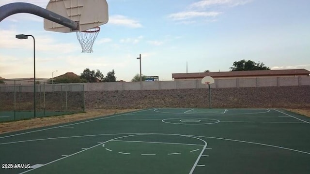 view of basketball court with community basketball court and fence