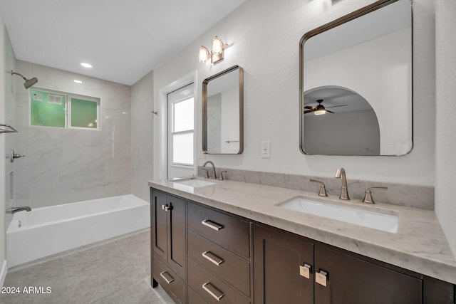 bathroom with tiled shower / bath combo, vanity, ceiling fan, and tile patterned floors