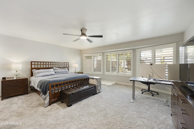 bedroom featuring baseboards, a ceiling fan, and light colored carpet