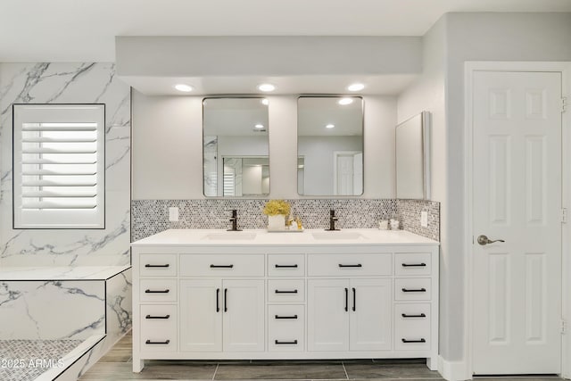 bathroom featuring double vanity, a sink, and wood finish floors