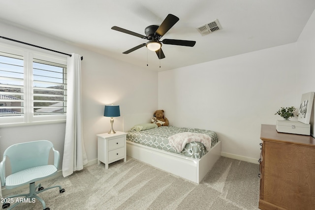 bedroom featuring visible vents, ceiling fan, light carpet, and baseboards