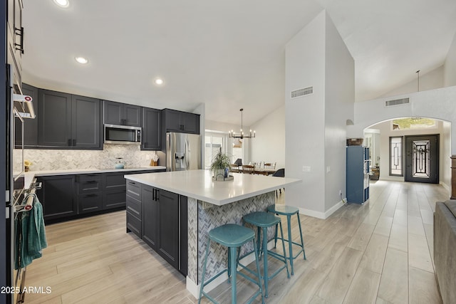 kitchen with light countertops, appliances with stainless steel finishes, visible vents, and pendant lighting