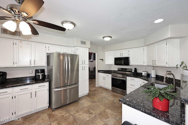 1640 W Gail Dr, Chandler, AZ 85224 - kitchen with stainless steel appliances, a sink, white cabinetry, ceiling fan, and dark stone counters