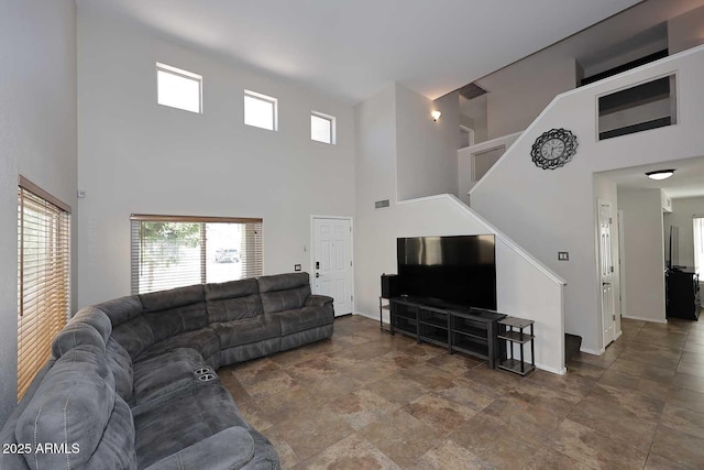 1640 W Gail Dr, Chandler, AZ 85224 - living area featuring a towering ceiling, stairs, healthy amount of natural light, and baseboards