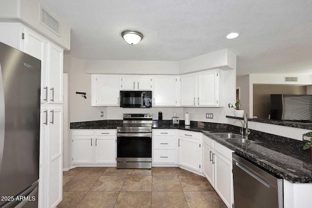 1640 W Gail Dr, Chandler, AZ 85224 - kitchen featuring stainless steel appliances, a sink, dark stone counters, white cabinets, and tile patterned flooring