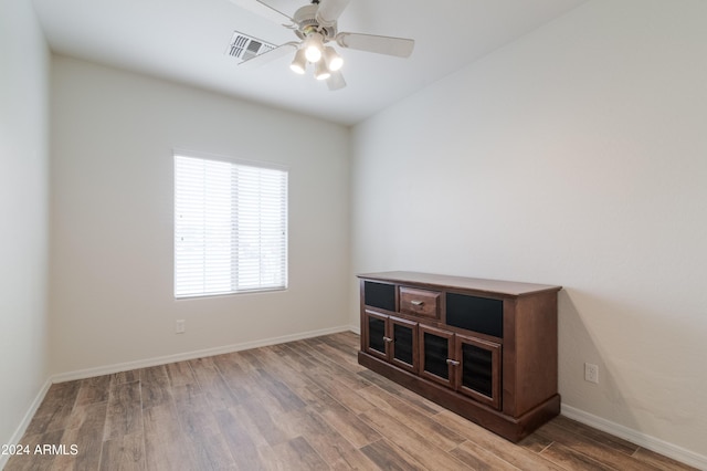 empty room featuring hardwood / wood-style floors and ceiling fan