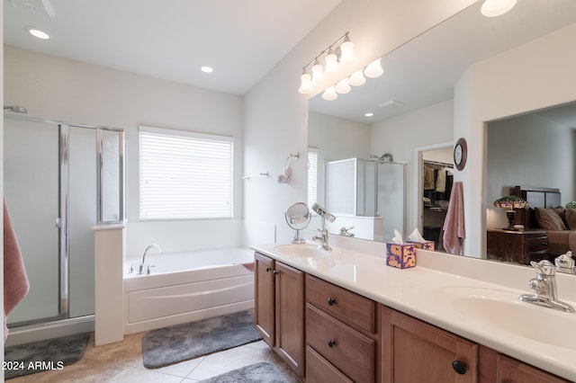 bathroom with tile patterned flooring, vanity, and independent shower and bath