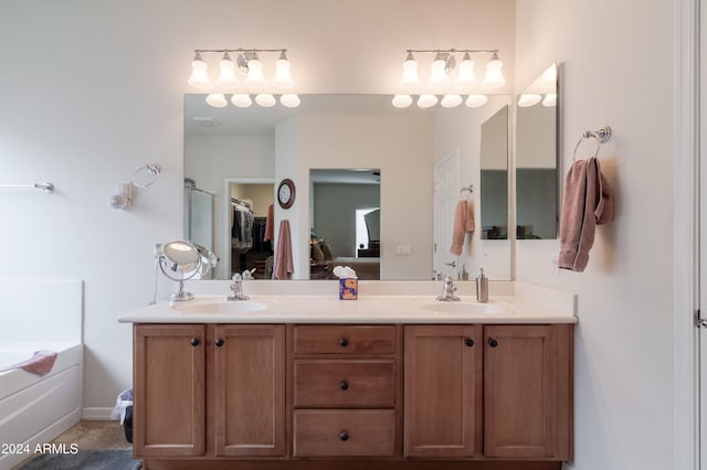 bathroom featuring tile patterned flooring, vanity, and a bathtub