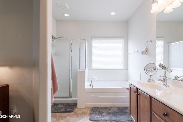 bathroom featuring vanity, separate shower and tub, and plenty of natural light