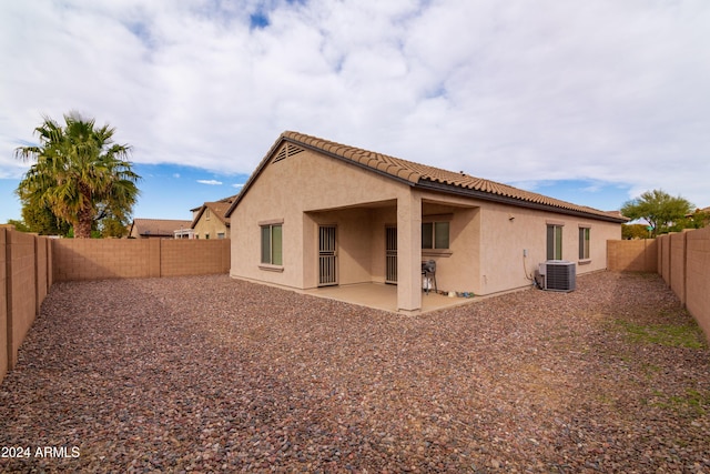 back of house with central AC unit and a patio area