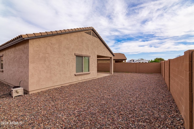 view of side of property featuring a patio area