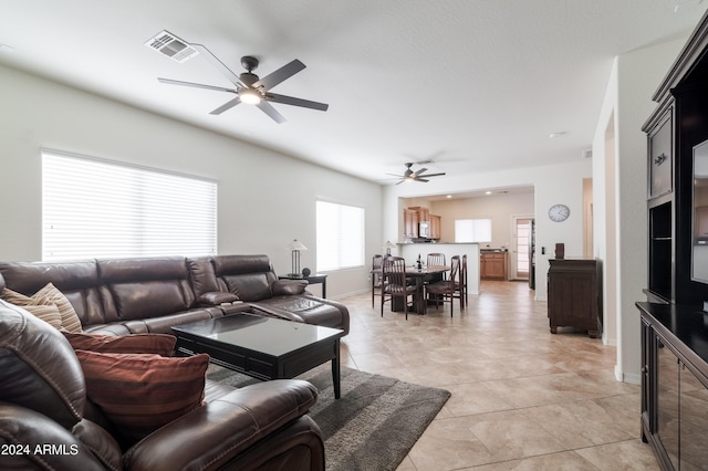 living room featuring ceiling fan and light tile patterned floors