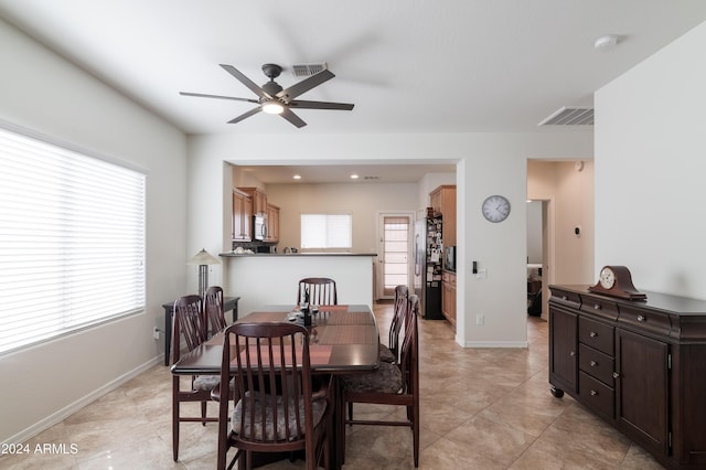 tiled dining room with ceiling fan and a healthy amount of sunlight