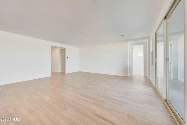 spare room featuring light wood-type flooring