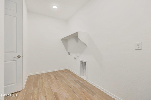 laundry room with baseboards, wood finish floors, laundry area, electric dryer hookup, and hookup for a gas dryer