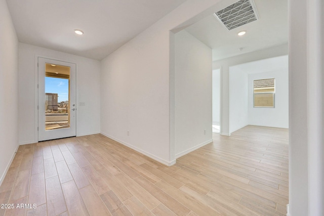 unfurnished room with recessed lighting, light wood-style floors, and visible vents