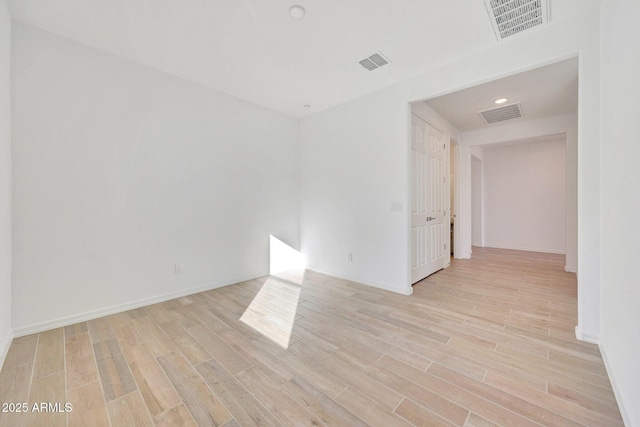 unfurnished room with visible vents and light wood-style flooring