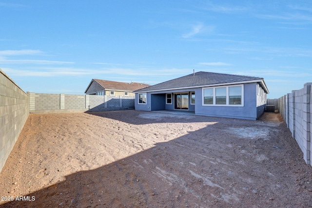 back of property featuring stucco siding and a fenced backyard