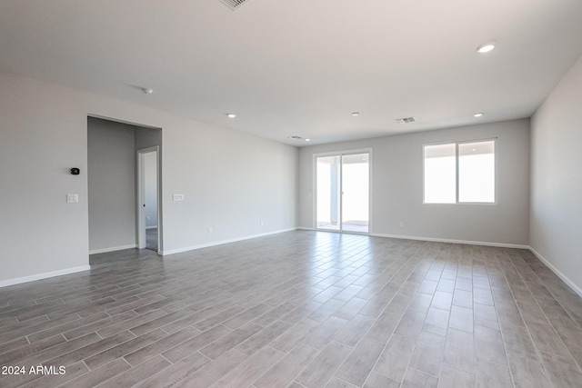 spare room featuring wood-type flooring