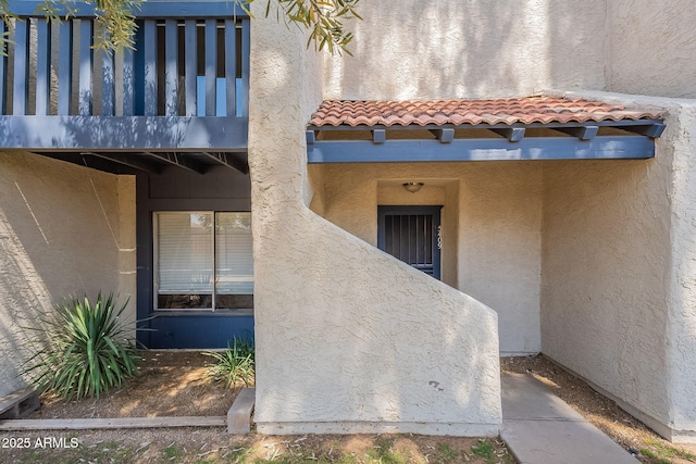 5409 W El Caminito Dr, Glendale, AZ 85302 - entrance to property featuring a tile roof, a balcony, and stucco siding