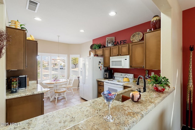 kitchen with light tile patterned flooring, hanging light fixtures, light stone counters, kitchen peninsula, and white appliances