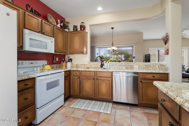 kitchen featuring pendant lighting, sink, white appliances, light tile patterned floors, and light stone counters