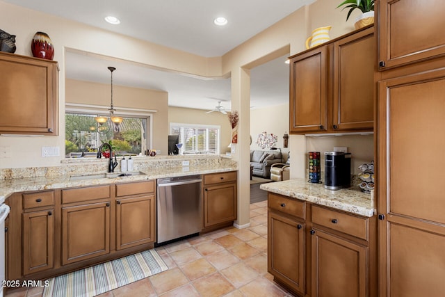 kitchen with light stone counters, sink, hanging light fixtures, and dishwasher