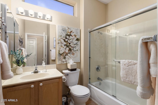 full bathroom with toilet, vanity, and bath / shower combo with glass door