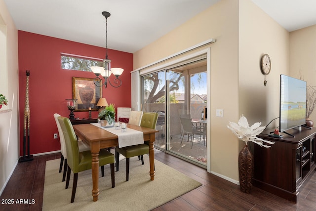 dining room with dark wood-type flooring, a chandelier, and a healthy amount of sunlight