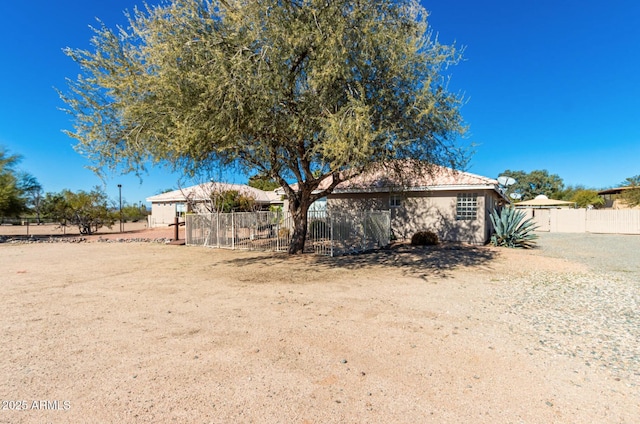 back of house with fence and stucco siding