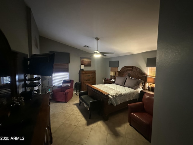 tiled bedroom with lofted ceiling and ceiling fan