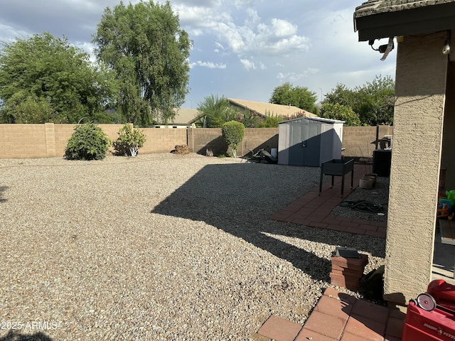 view of yard with a shed and a patio area