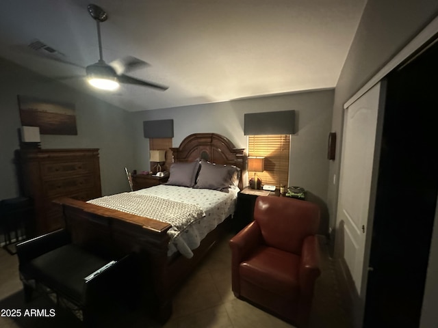 tiled bedroom featuring ceiling fan and a closet