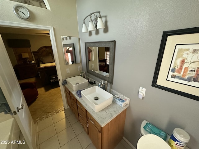 bathroom with tile patterned flooring, sink, and toilet