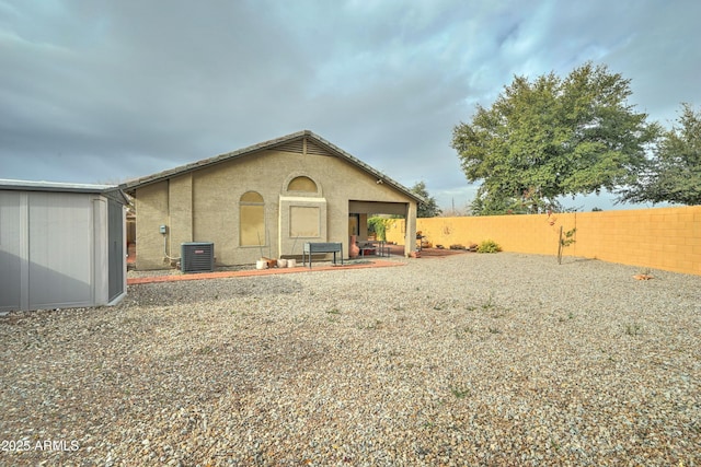 back of house featuring cooling unit and a patio area