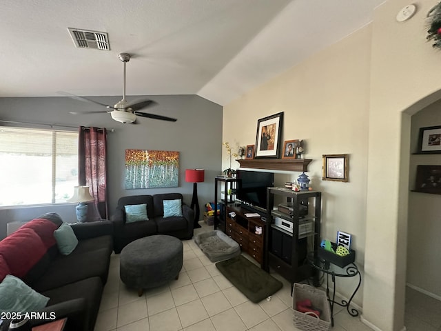 living room with lofted ceiling, light tile patterned floors, and ceiling fan