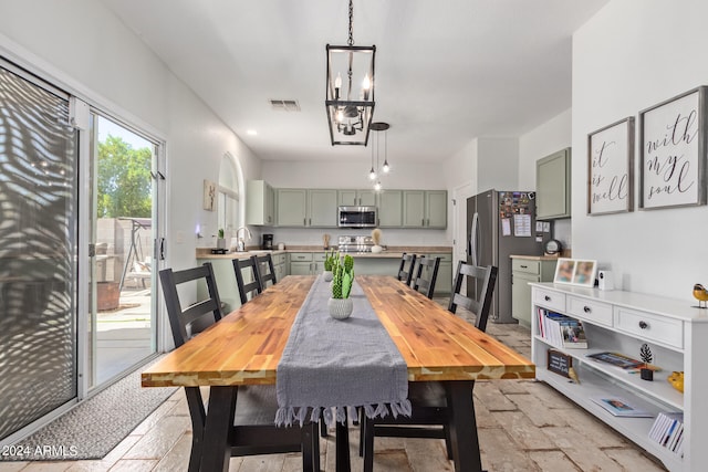 dining room with a chandelier and sink