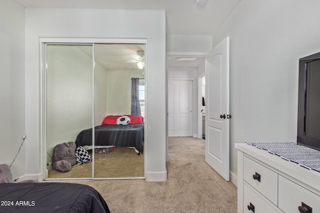 bedroom with a closet and light colored carpet