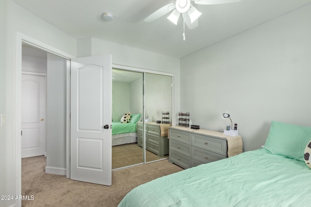 carpeted bedroom with ceiling fan and a closet