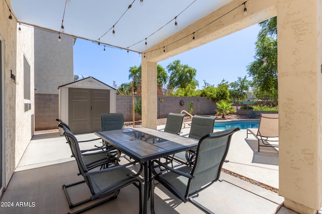 view of patio featuring a storage unit and a fenced in pool