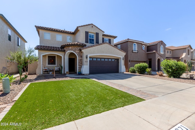 mediterranean / spanish-style home featuring a front yard and a garage